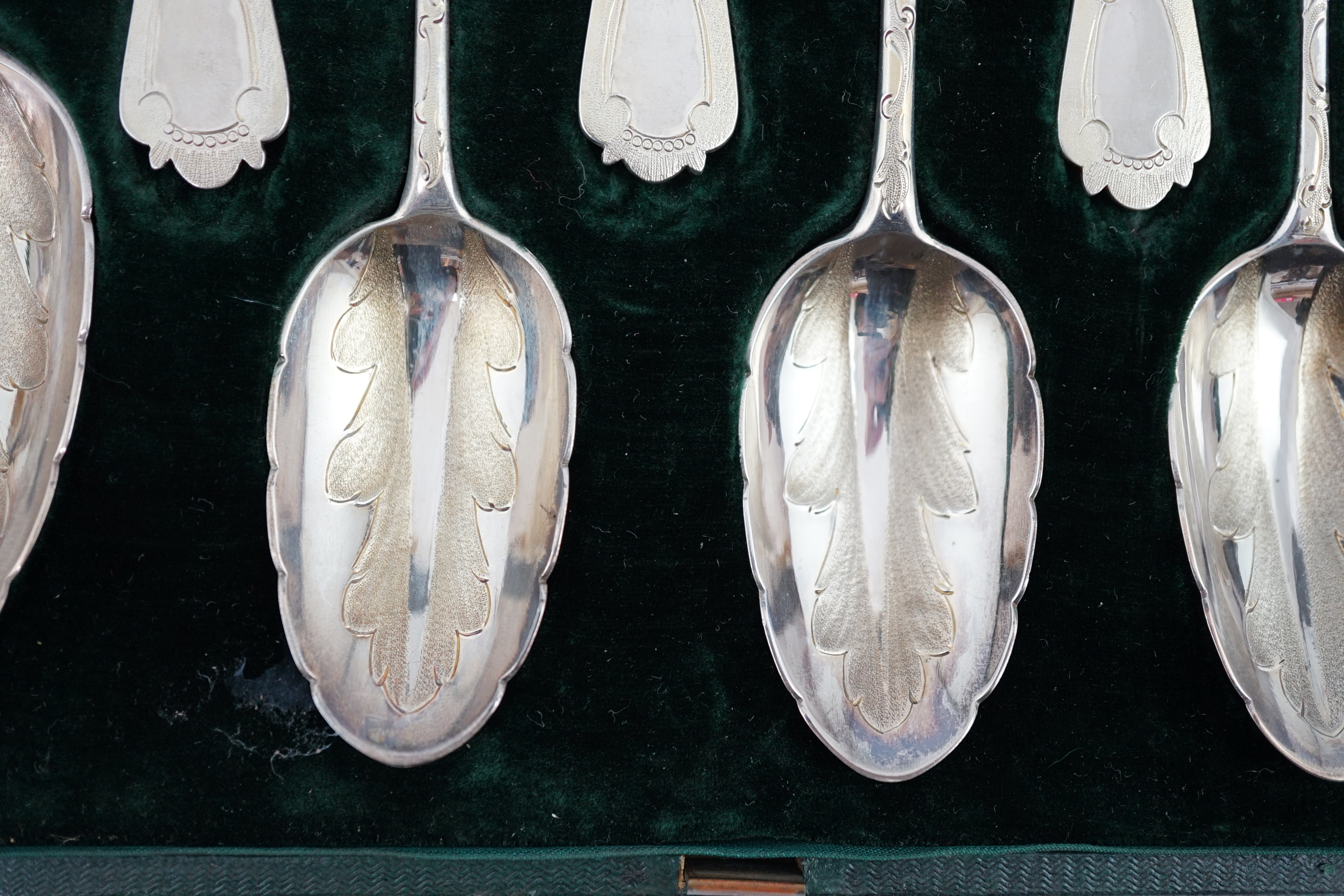 A Victorian cased set of six engraved silver dessert spoons and two serving spoons, by George Adams